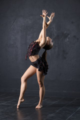 Woman dance against textured wall background