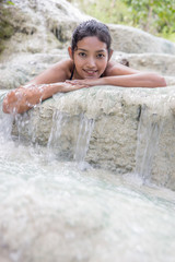 woman lying in a waterfall