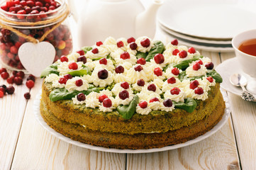 Spinach cake with cream and cranberries.