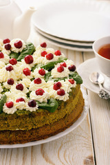 Spinach cake with cream and cranberries.