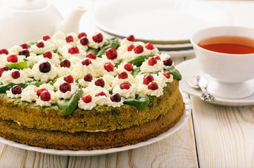 Spinach cake with cream and cranberries.