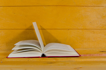 Opened book on wooden background