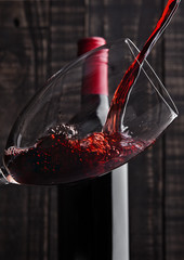 Pouring red wine into the glass from bottle