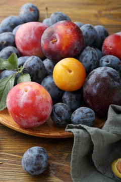 Fresh and ripe plums on plate