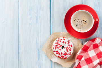 Donut with heart shaped decor and coffee