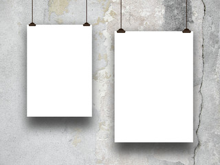 Two blank frames hanged by clips against gray cracked concrete wall background