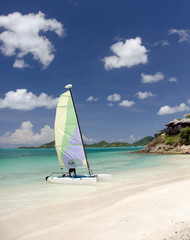 Catamaran with colorful sails departs from Cocobay