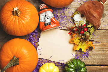 Happy Halloween postcard. Pumpkins and decor against an old wood background. Vintage toned