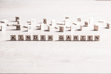 wooden elements with letter collected to word kinder garten
