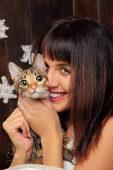 beautiful smiling brunette girl and her grey cat.