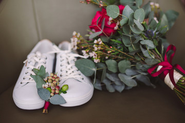 wedding set of bridal bouquet and white sport shoes and groom boutonniere