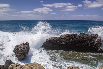 Waves crashing down at the rock on the Mediterranean seashore