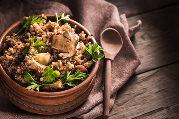 Bowl of buckwheat porridge with mushrooms