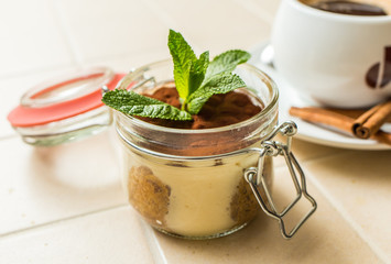 luxurious dessert tiramisu in glasses, decorated with blueberries and mint