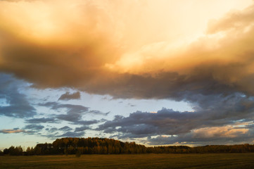 Obraz na płótnie Canvas Dark stormy clouds over field