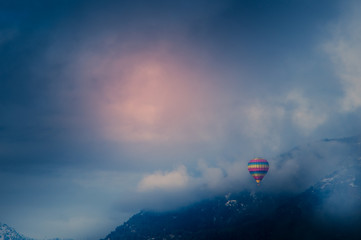 balloon among snowy mountains and clouds
