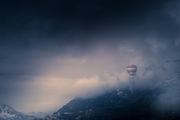 balloon among snowy mountains and clouds