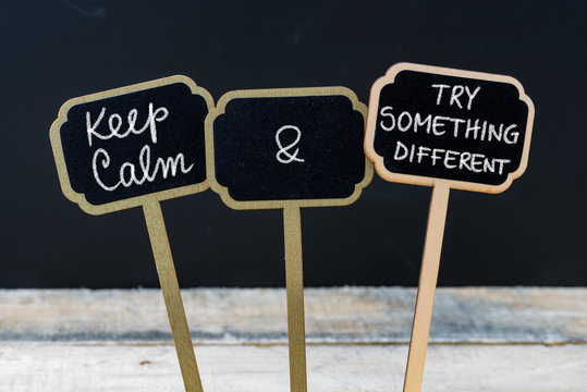 Keep Calm and Try Something Different message written with chalk on mini blackboard labels