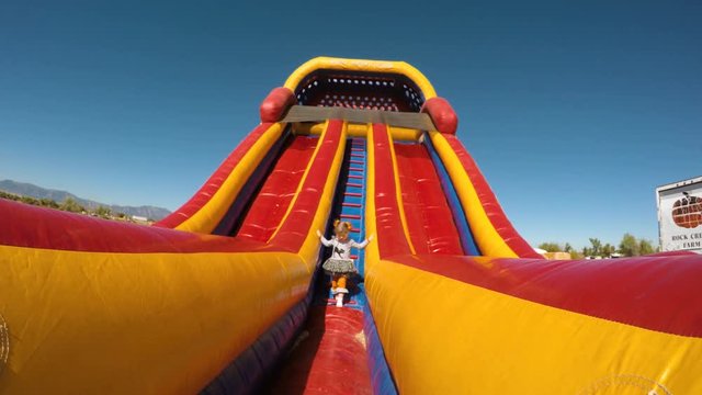 Girl playing on large bounce house