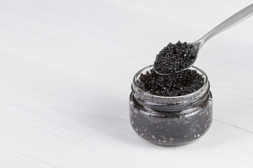Fototapeta na wymiar close-up view of spoon with black sturgeon caviar