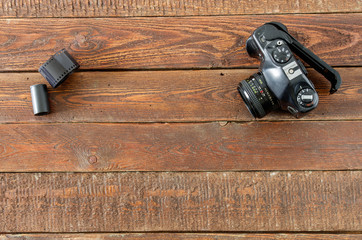 Vintage camera and film on wood table