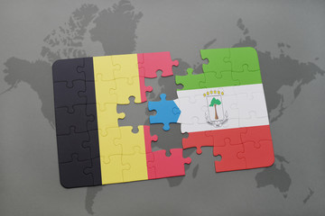 puzzle with the national flag of belgium and equatorial guinea on a world map background.