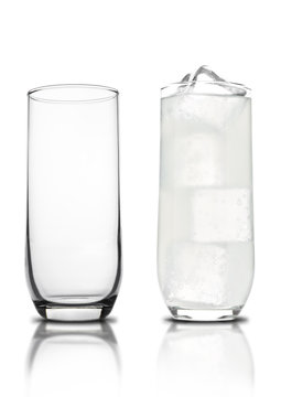 Glass of lemon lemonade with ice cubes empty glass