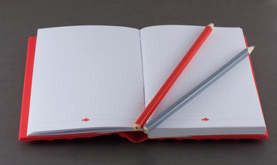 Notepad with pencil on a gray background