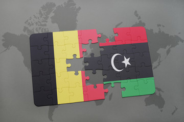 puzzle with the national flag of belgium and libya on a world map background.