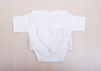 Baby goods. Baby blouse and pants sliders pijama. Children's clothing diapers pajamas mittens socks vests sliders white