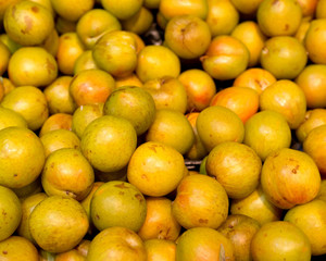 Fresh organic yellow plums in local fresh market store