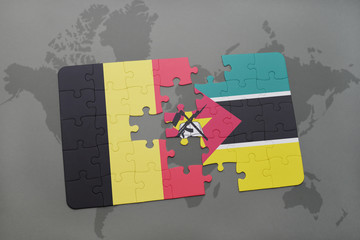 puzzle with the national flag of belgium and mozambique on a world map background.