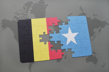 puzzle with the national flag of belgium and somalia on a world map background.