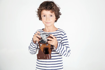  Cheerful smiling child (boy) holding a film camera 