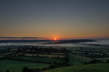 Fototapeta na wymiar Sunrise over misty fields of Somerset
