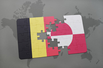 puzzle with the national flag of belgium and greenland on a world map background.