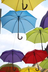 Fototapeta na wymiar Colorful Umbrellas Over the Street Vertical