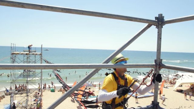 Man in Fixes Scaffold Beats Hammer