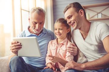 Grandpa, dad and little girl at home