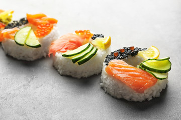 Sushi doughnuts on grey textured background