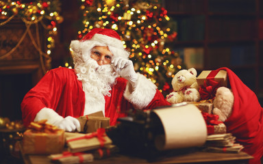 Santa Claus at desk with letters,   gifts near Christmas tree
