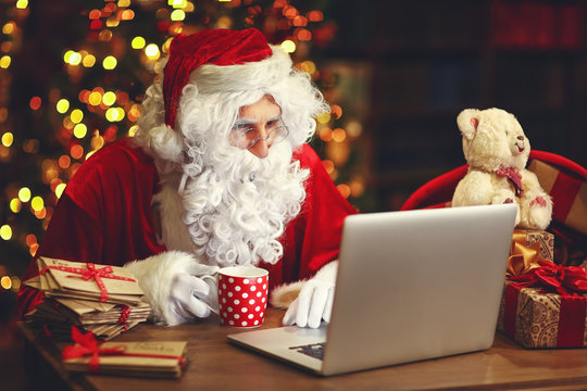 Christmas. Santa Claus With Laptop Reading Letter