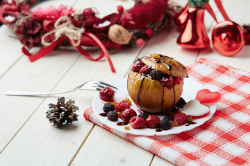 Baked apple with berries and chocolate sauce. Wooden background. Healthy lifestyle.Diet and weight loss concept. Low calories dinner. Vitamin B. Healthy food.