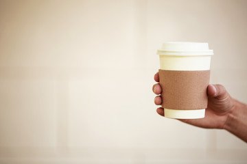 Paper cup of takeaway coffee in the hand - 123848447