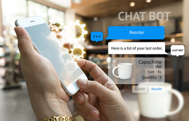 Chat bot and future marketing concept . Customer hand holding smart phone for reorder coffee and popup out phone screen with automatic chatbot message screen , coffee shop background