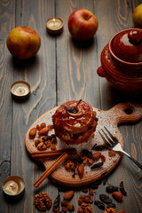 Baked apple with nuts, raisins and honey. Wooden background. Healthy lifestyle.Diet and weight loss concept. Low calories dinner. Vitamin B. Healthy food.