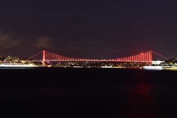 Istanbul bosphorus bridge with red lights at night