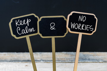 Keep Calm and No Worries message written with chalk on mini blackboard labels