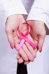 Female hands with pink ribbon