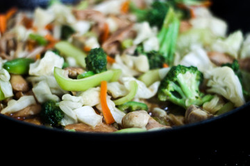 Stir fry with mixed vegetables and chicken in a wok